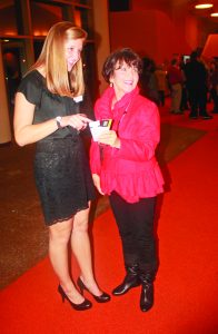 Senior Sarah Lulich, a Head Norton Center Usher, directs a patron to her seat during the night of the Béla Fleck and Brooklyn Rider concert on Nov. 16.