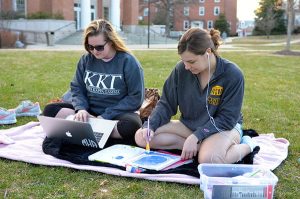 Pictured: Sophomores Meredith Harbison and Kelsie Essel Photo taken by Katherine Mackin Meredith Harbison and Kelsie Essel take advantage of the warm spring weather to do homework on the lawn.